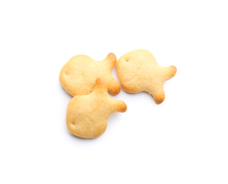 Photo of Delicious crispy goldfish crackers on white background, top view