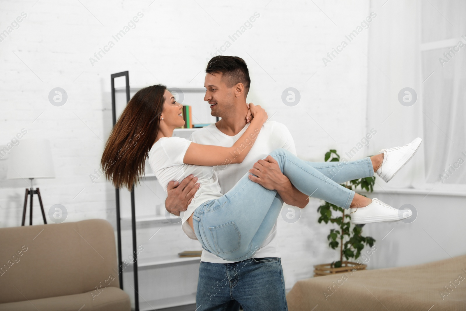 Photo of Happy young couple dancing together at home