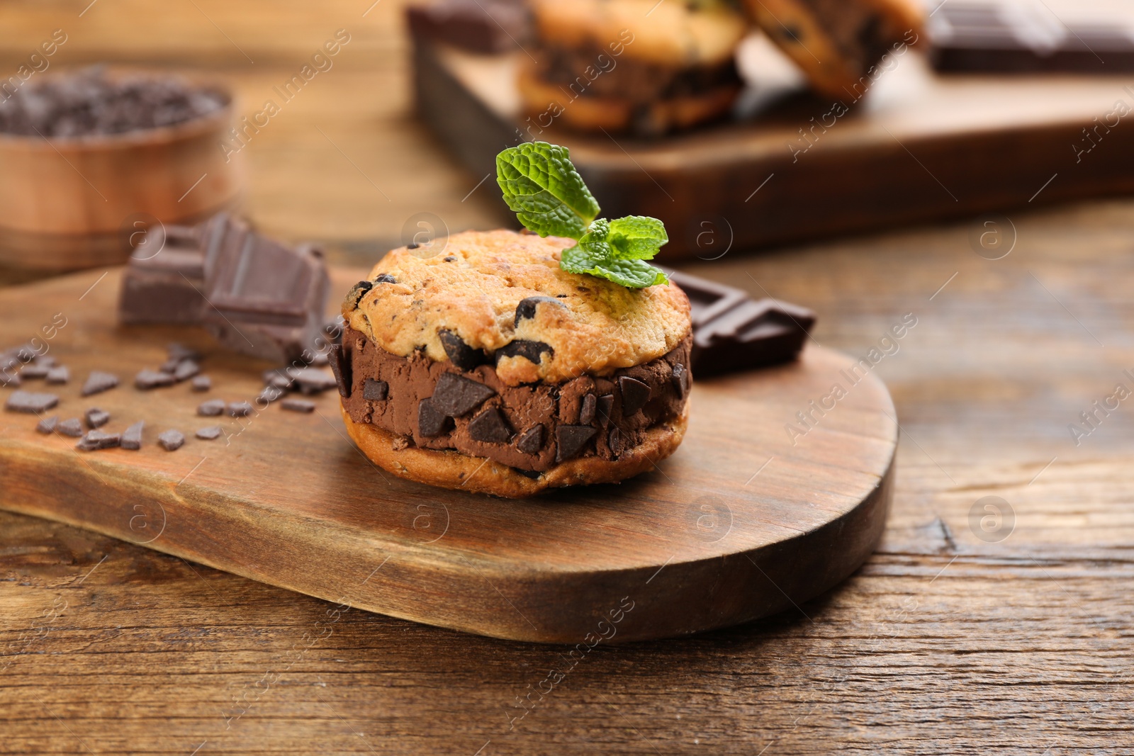 Photo of Sweet delicious ice cream cookie sandwich on wooden table