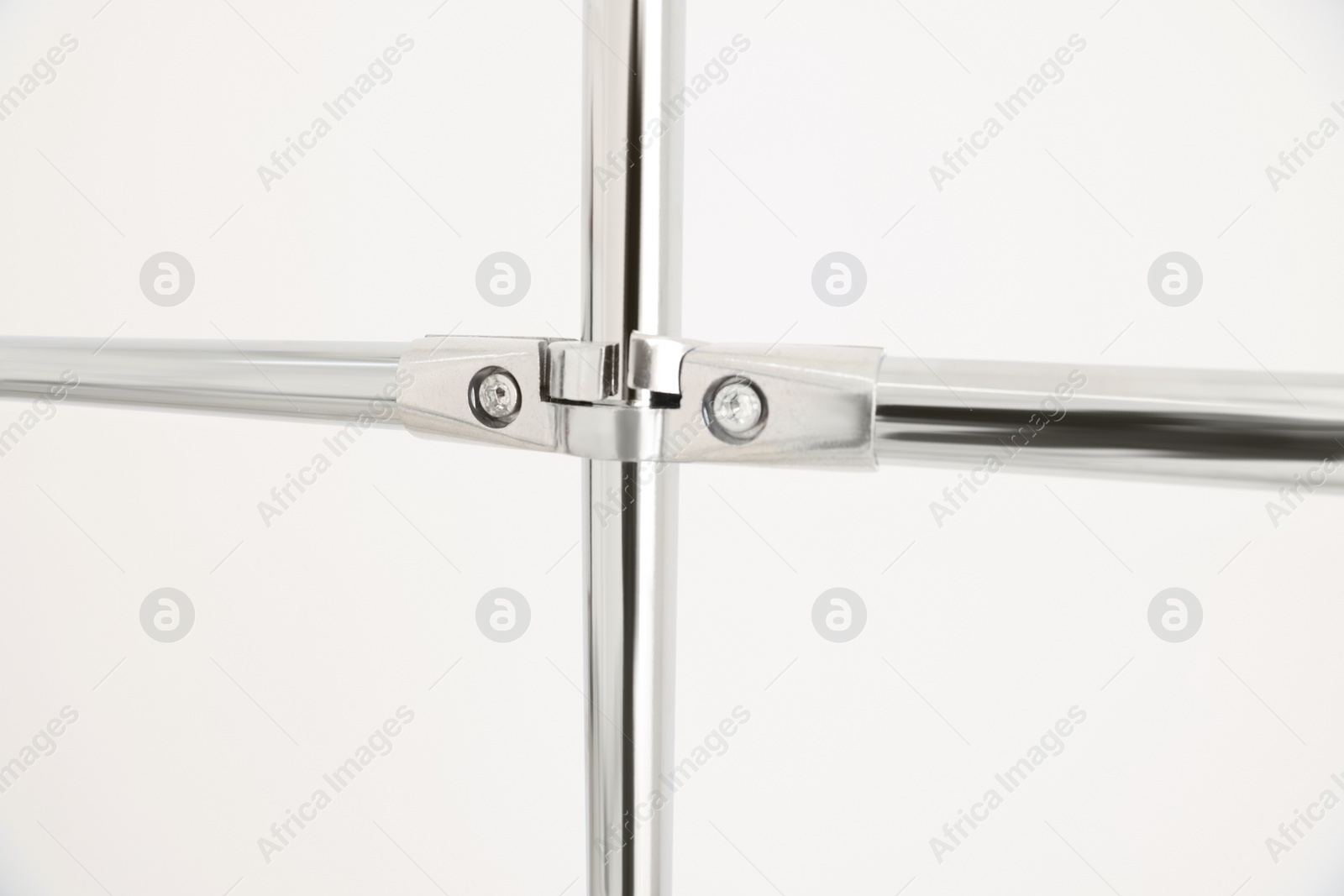 Photo of New modern metal pipes against white background