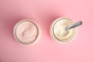 Tasty organic yogurt on pink background, flat lay