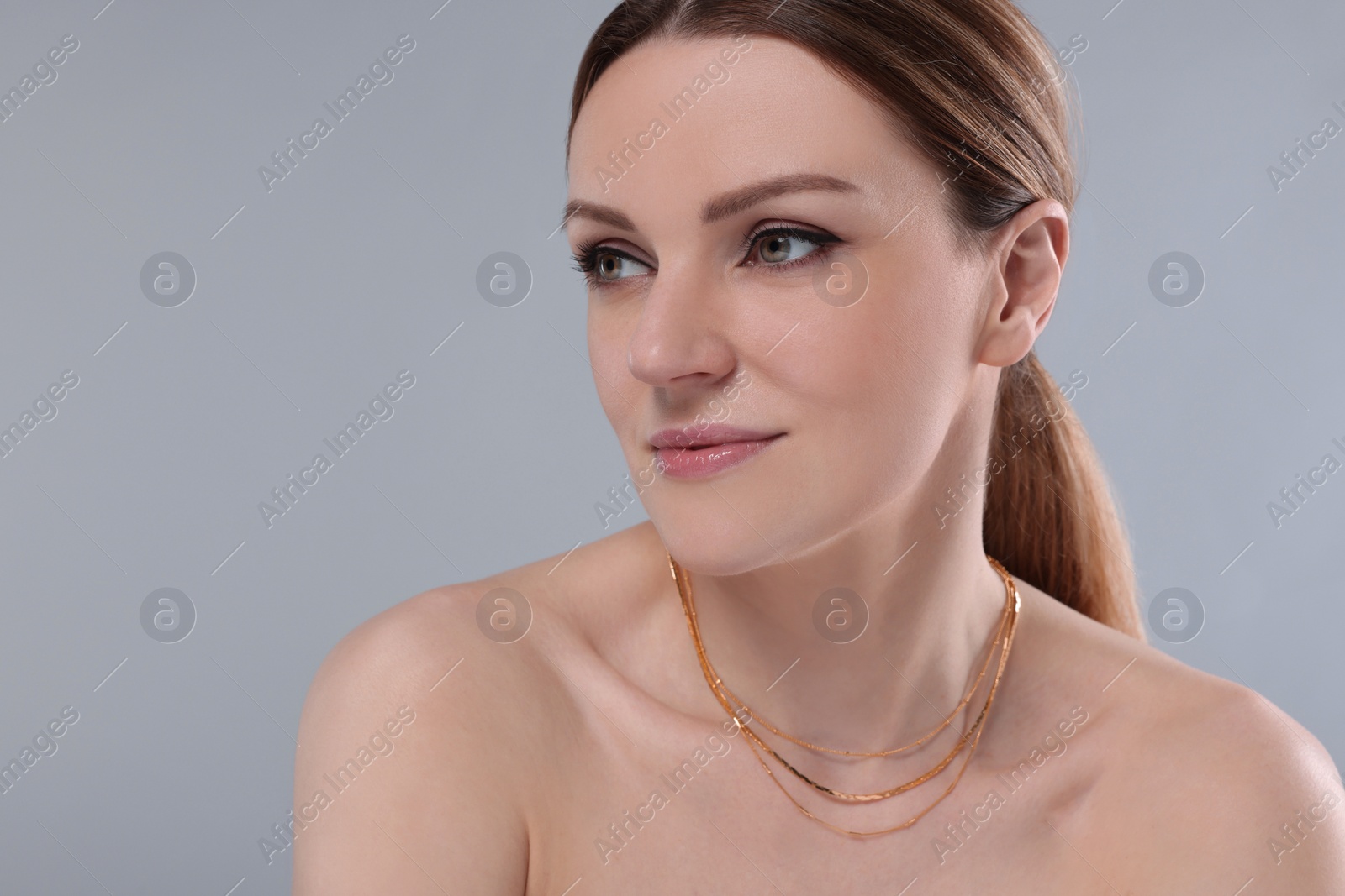 Photo of Beautiful woman with elegant necklace on light grey background. Space for text