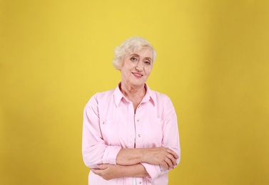 Photo of Senior woman in casual outfit on yellow background