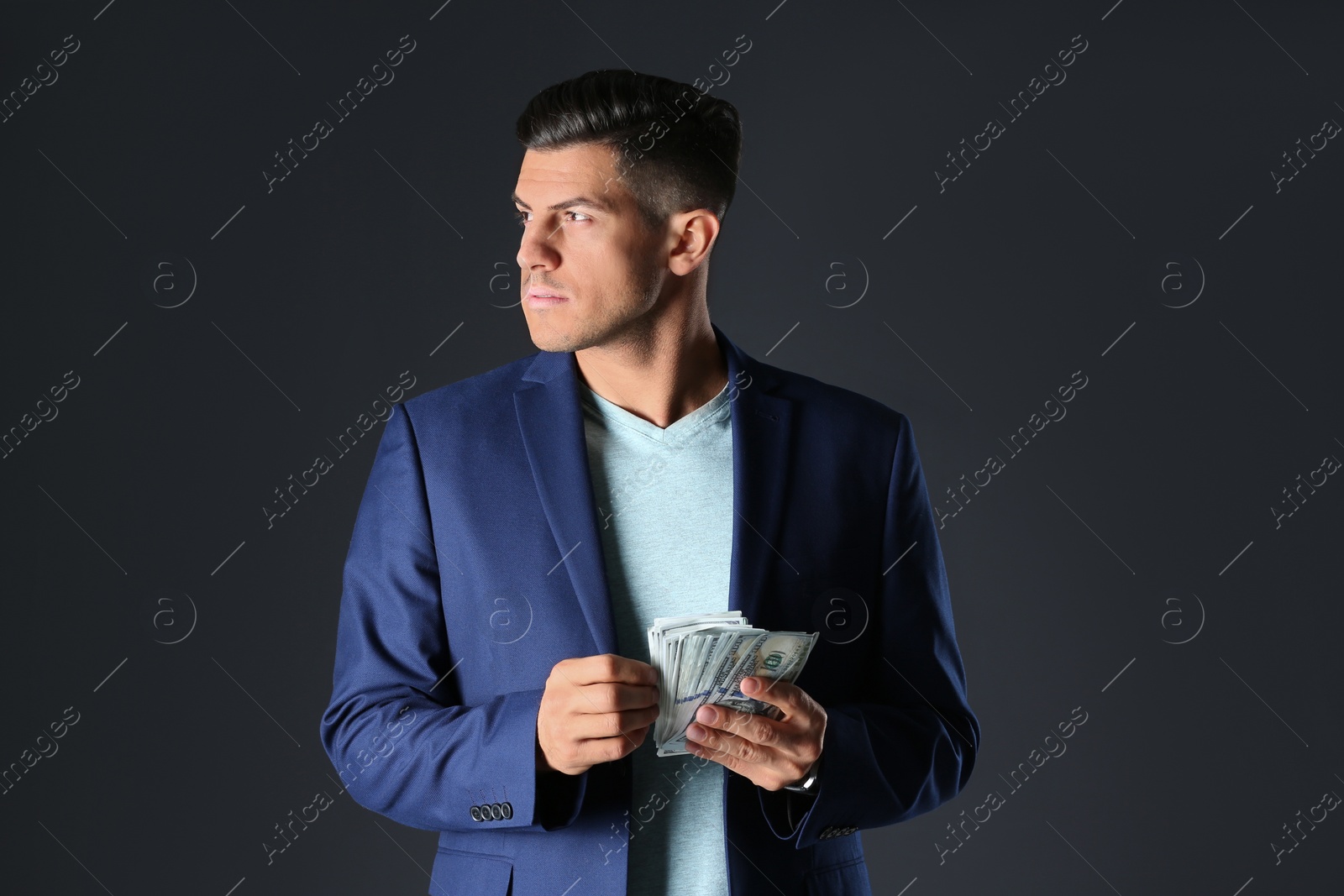 Photo of Man with bribe money on black background
