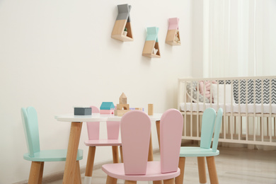 Cute baby room interior with cot and little table