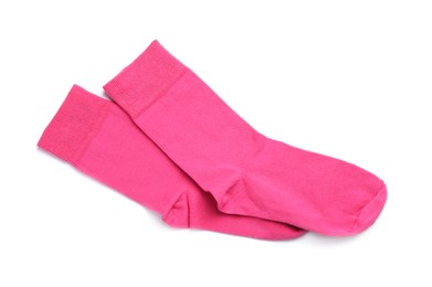 Photo of Pair of pink socks on white background, top view