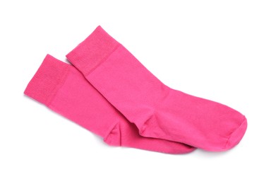 Pair of pink socks on white background, top view