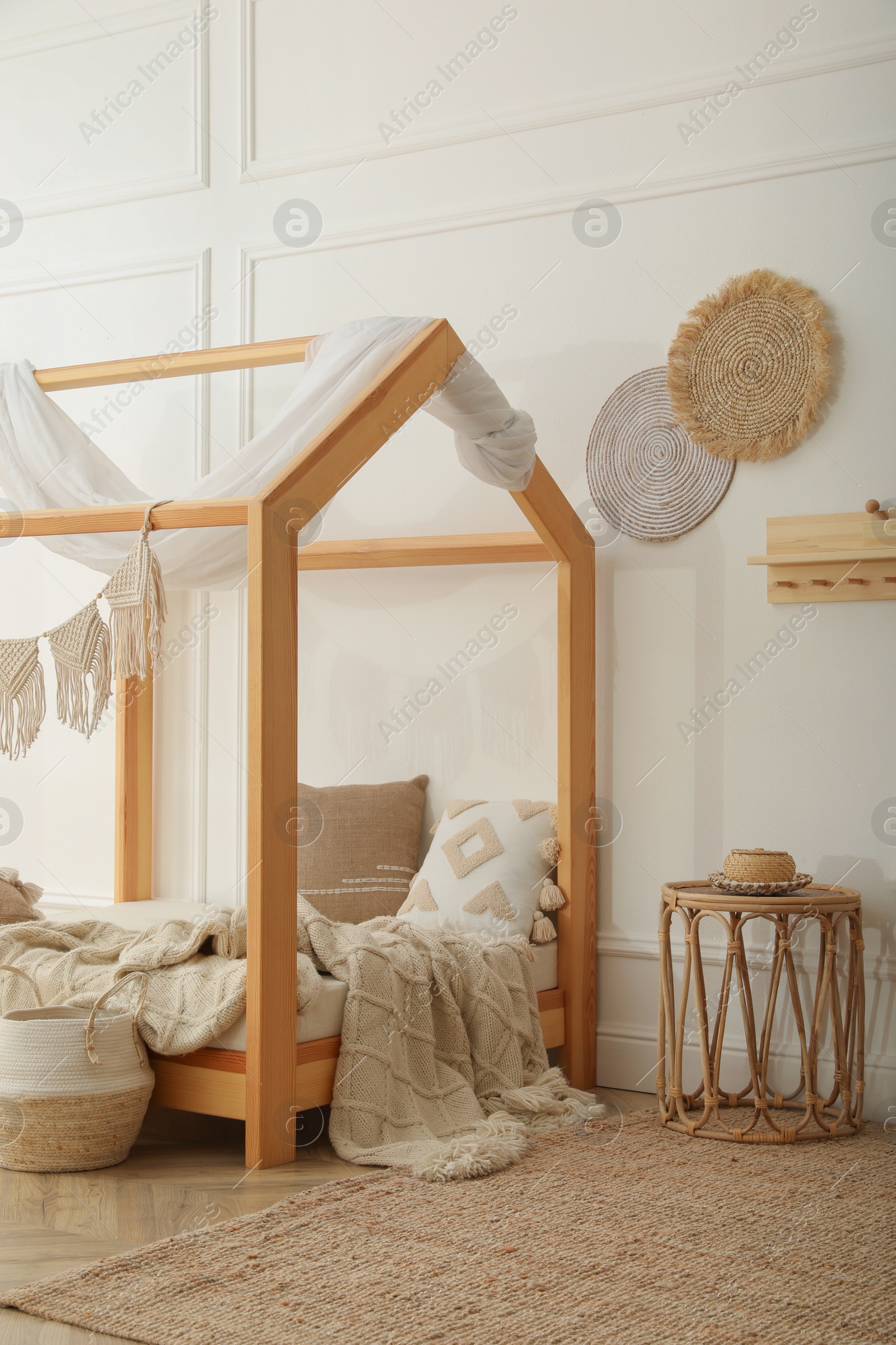 Photo of Stylish child room interior with house bed