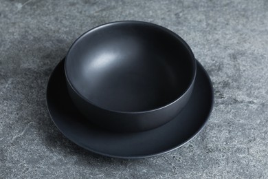 Photo of Empty clean ceramic dishware on grey table, closeup