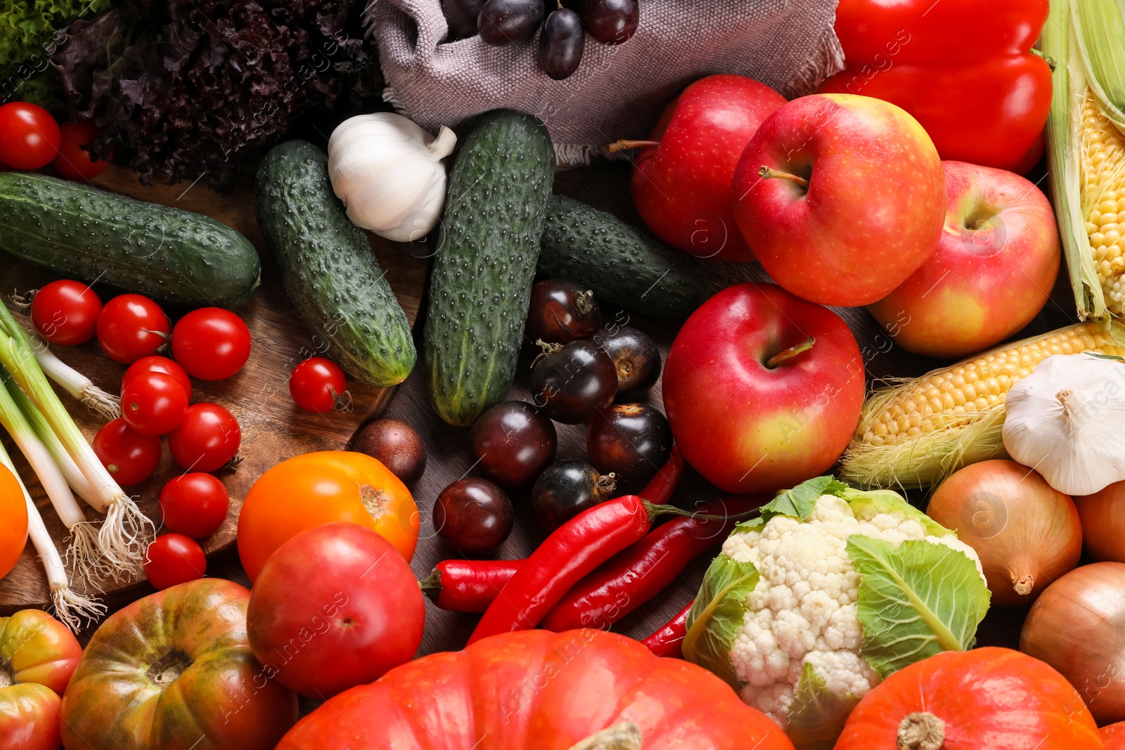 Photo of Different fresh ripe vegetables and fruits on wooden table, above view