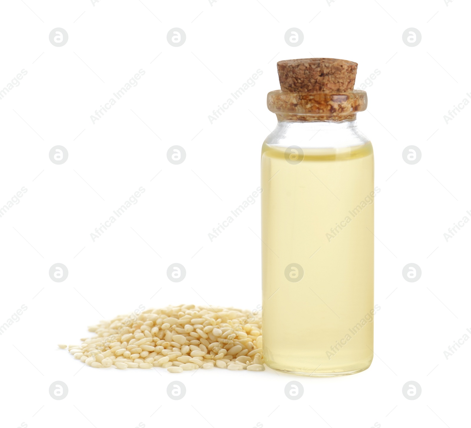 Photo of Glass bottle with fresh sesame oil and seeds isolated on white