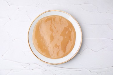 Photo of Making kombucha. Scoby fungus on white textured table, top view