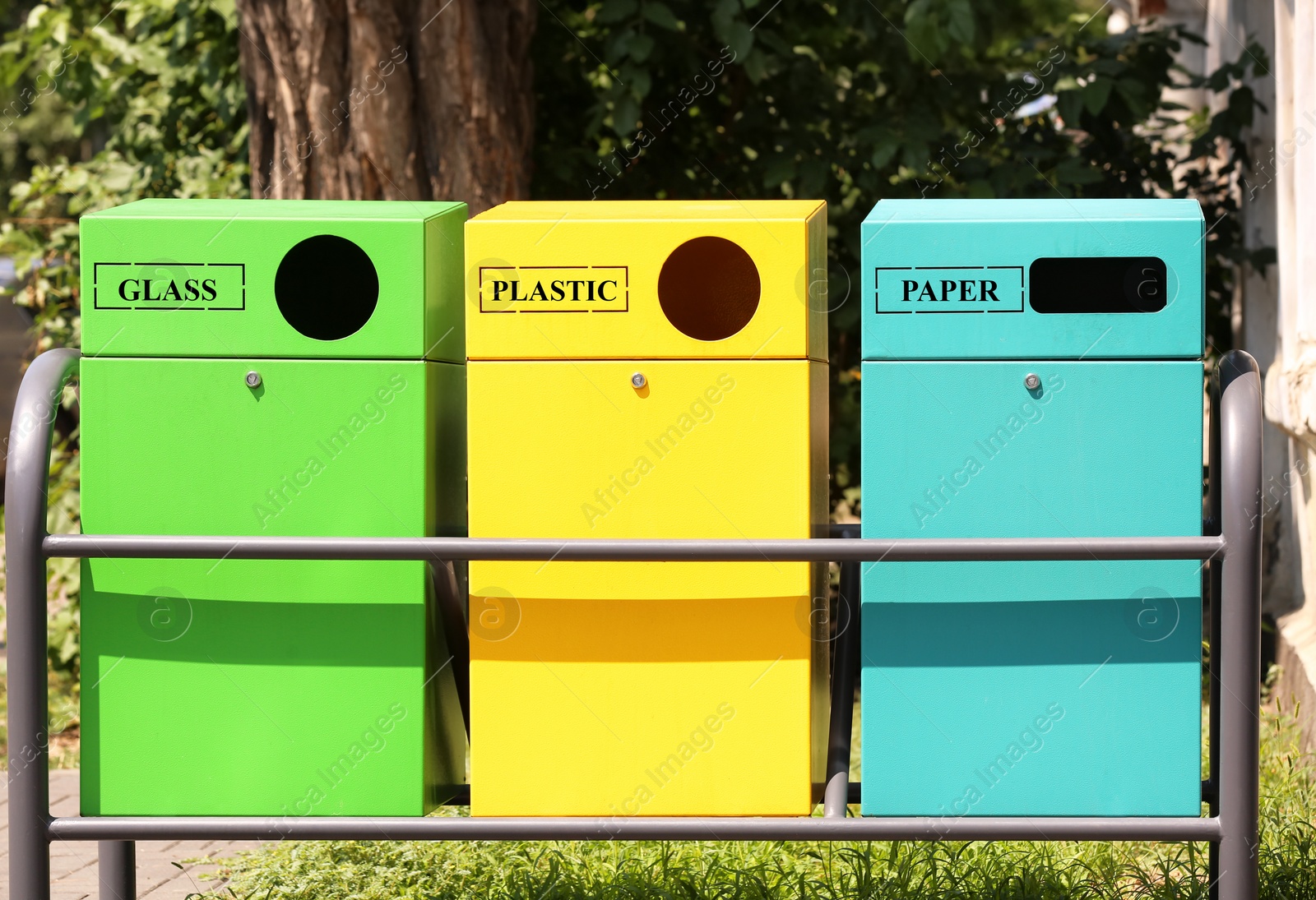 Photo of Waste sorting bins on city street. Recycling concept