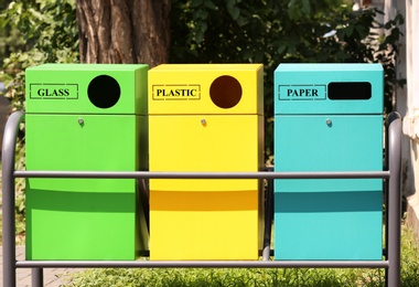 Waste sorting bins on city street. Recycling concept