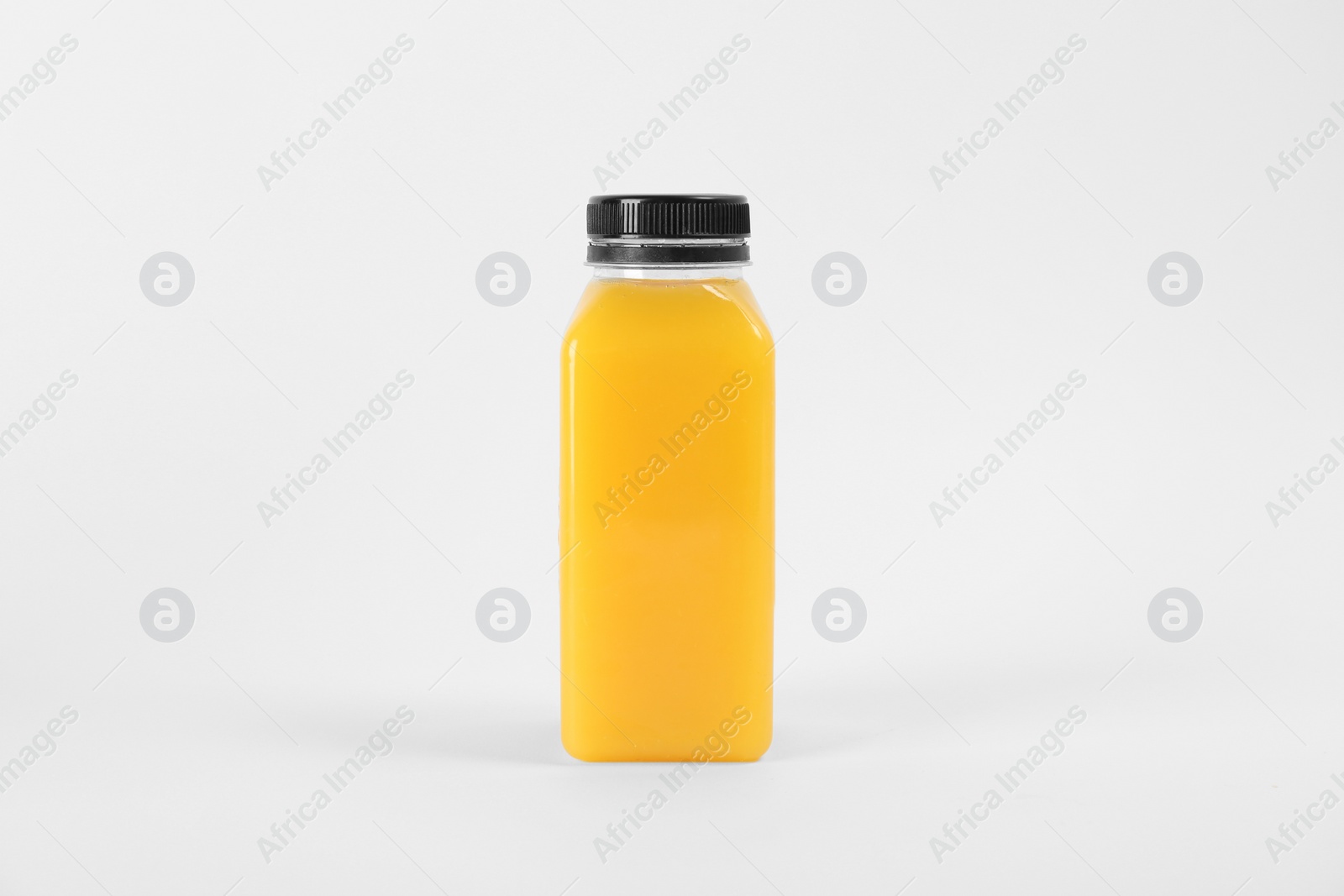 Photo of Bottle with delicious fresh juice on white background