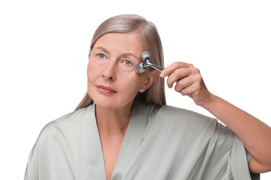 Photo of Woman massaging her face with metal roller isolated on white