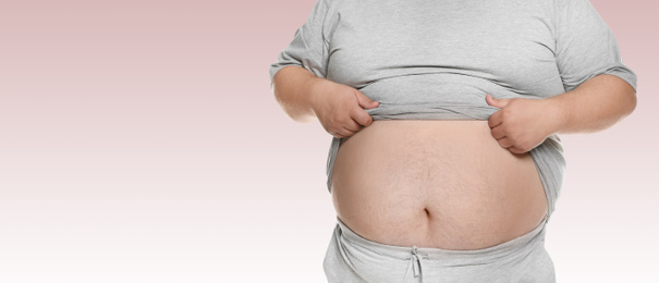 Image of Closeup view of overweight man on color background, space for text. Banner design