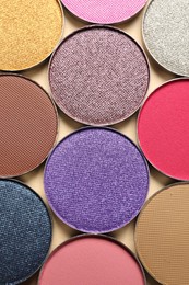 Different beautiful eye shadows on beige background, flat lay