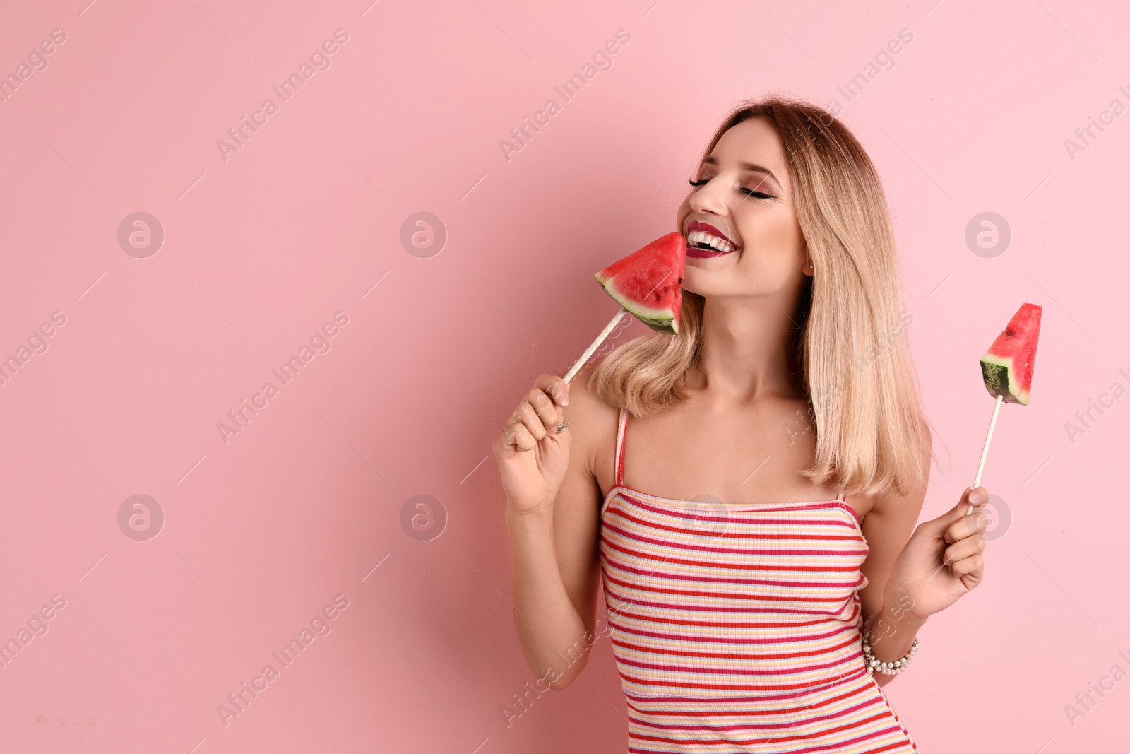 Photo of Pretty young woman with juicy watermelon on color background