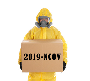 Man wearing chemical protective suit with cardboard box on white background. Coronavirus outbreak