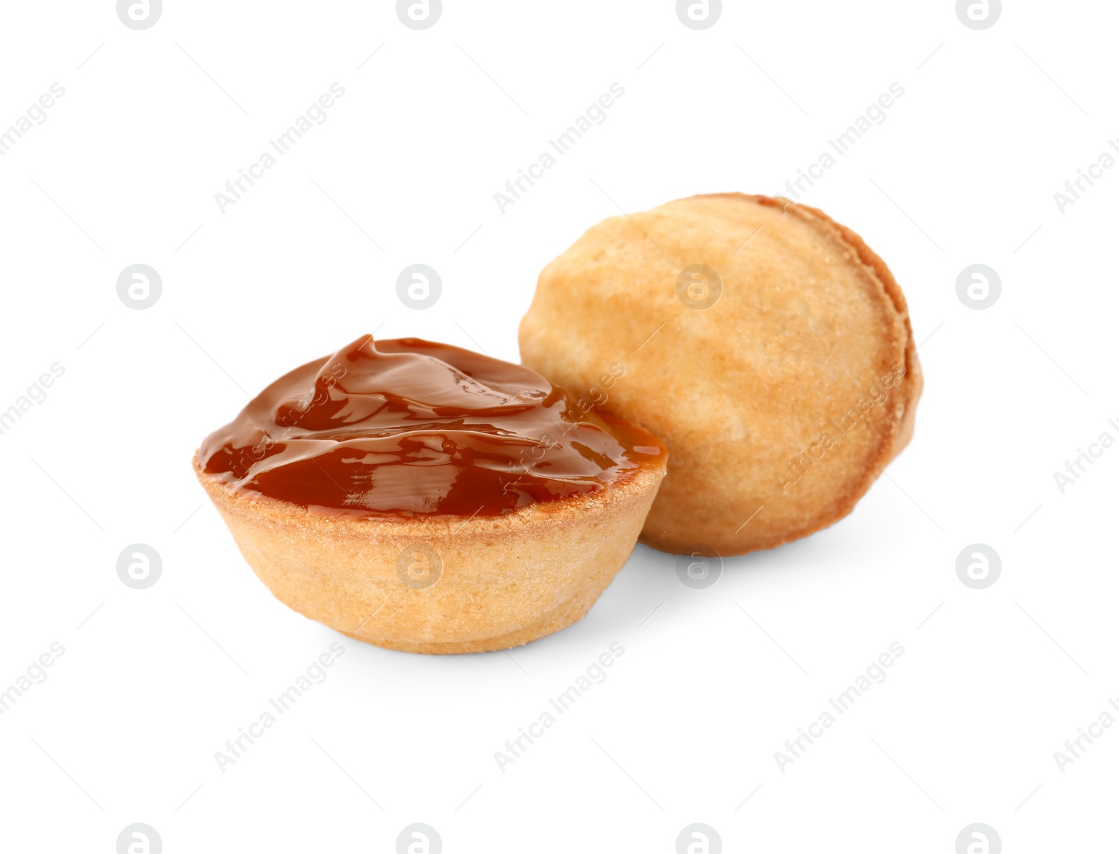 Photo of Delicious nut shaped cookies with boiled condensed milk on white background