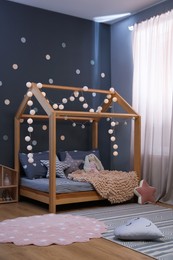 Photo of Stylish child room interior with comfortable bed