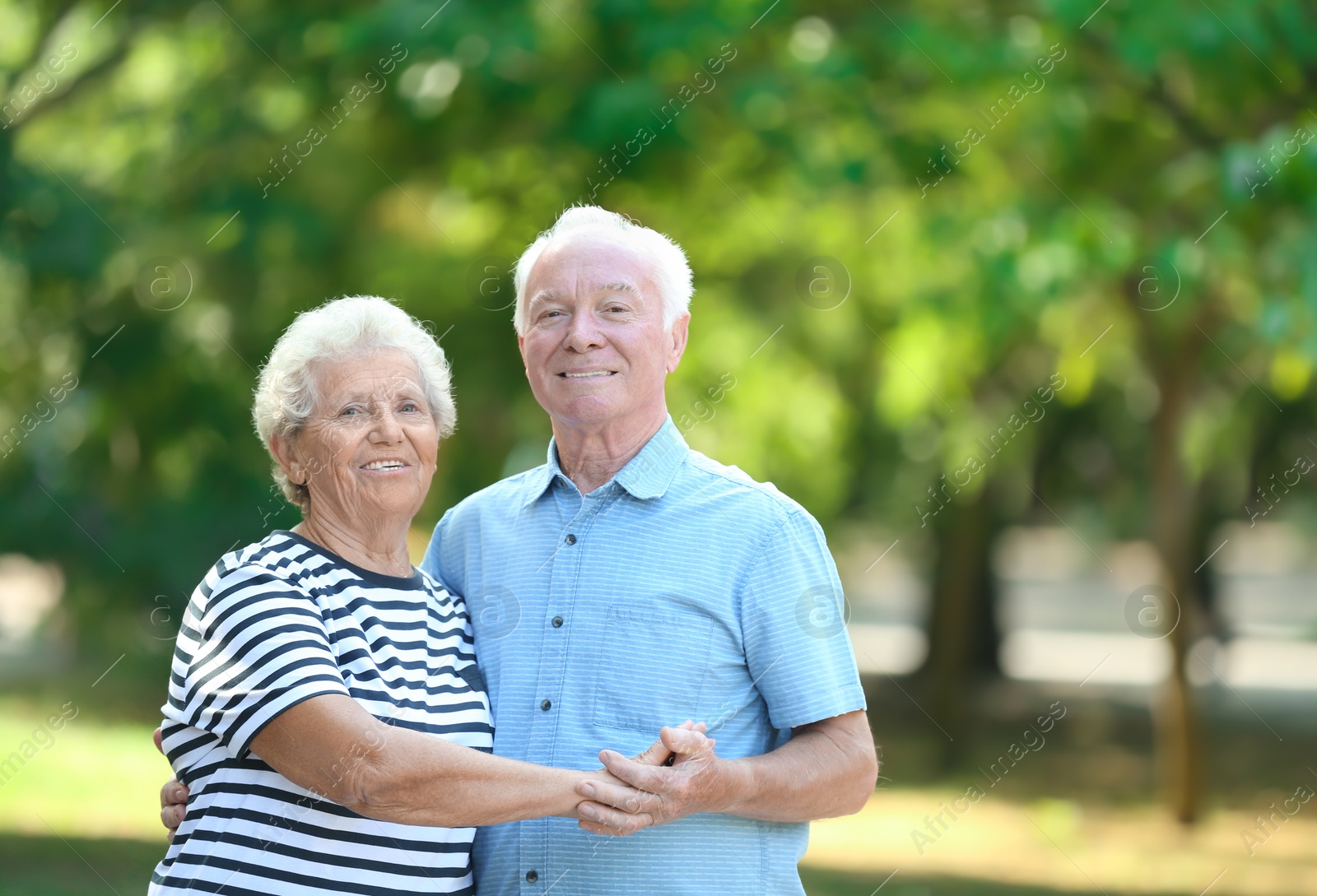 Photo of Portrait of cute elderly couple in park