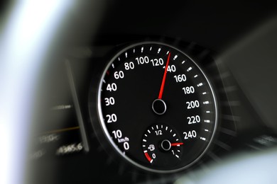 Image of Speedometer on car dashboard, closeup. Motion blur effect