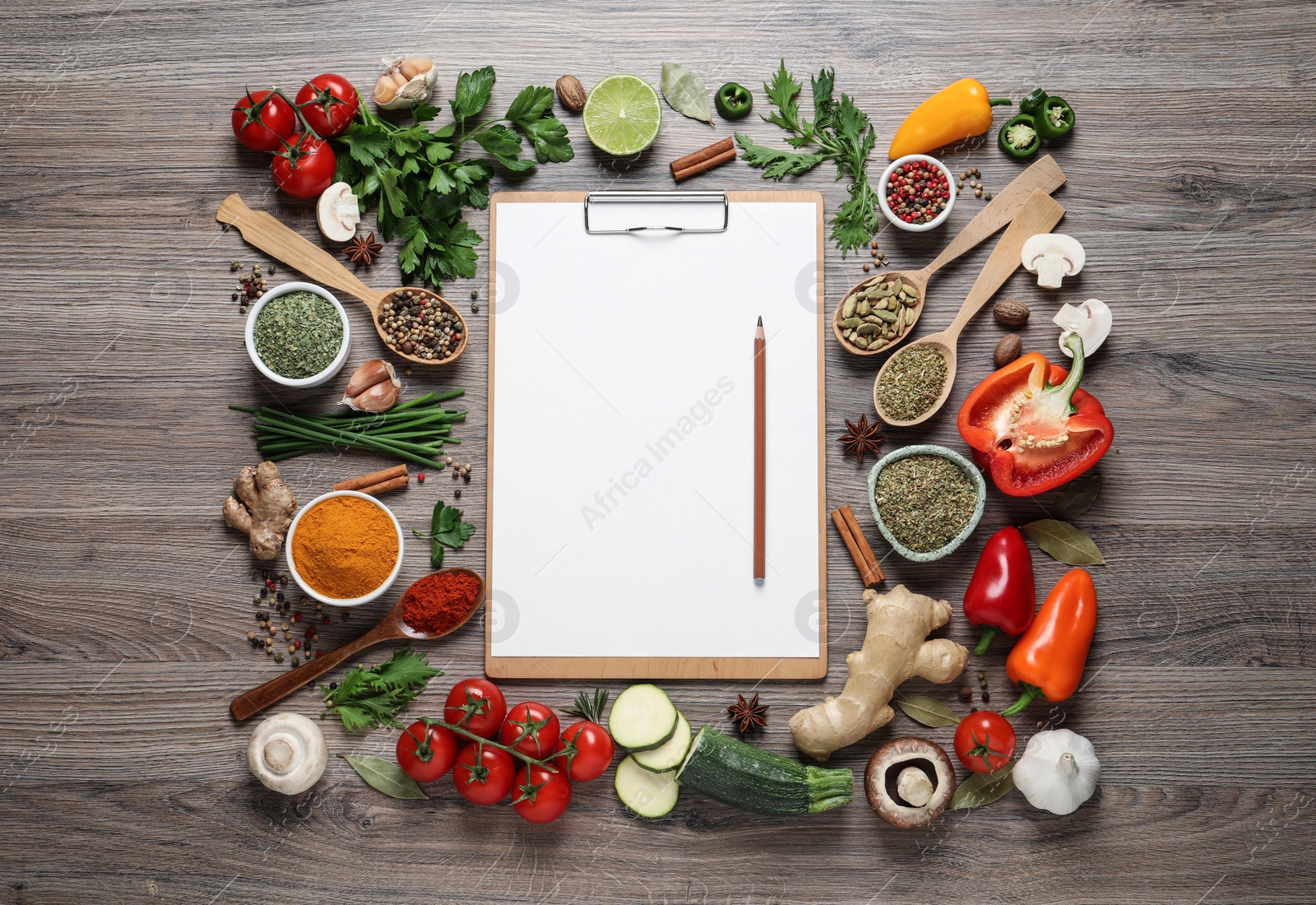 Photo of Open recipe book and different ingredients on wooden table, flat lay. Space for text