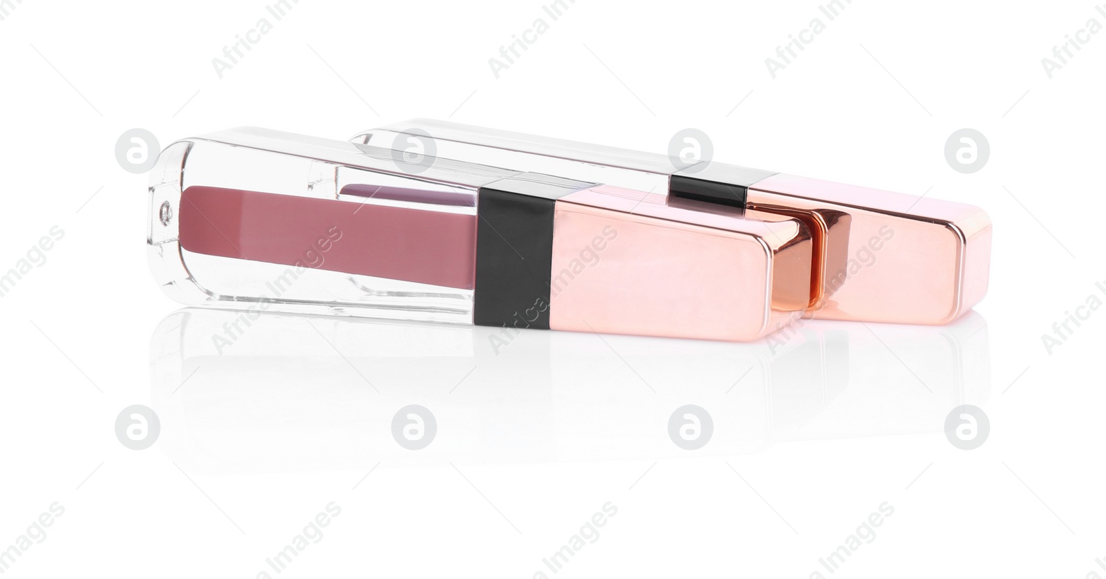 Photo of Two lip glosses isolated on white. Cosmetic products