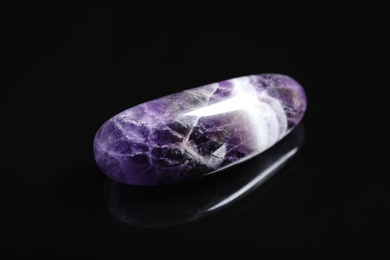 Photo of Beautiful purple amethyst chevron gemstone on black background