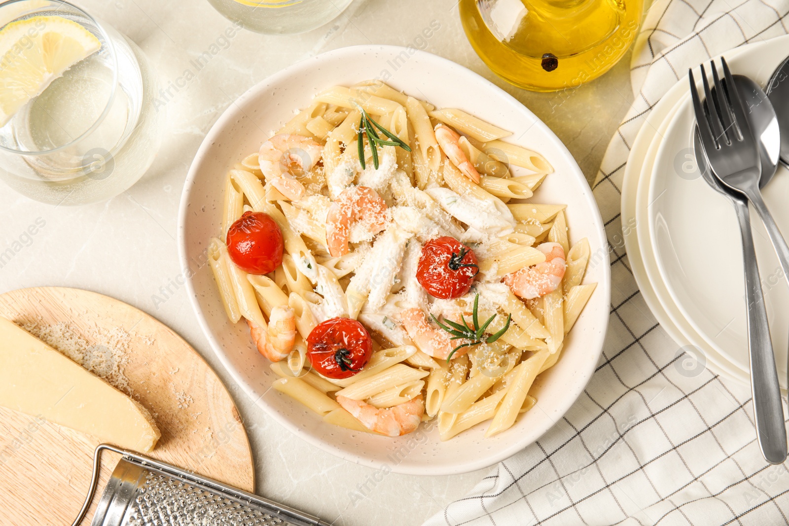 Photo of Delicious pasta with shrimps on marble table, flat lay