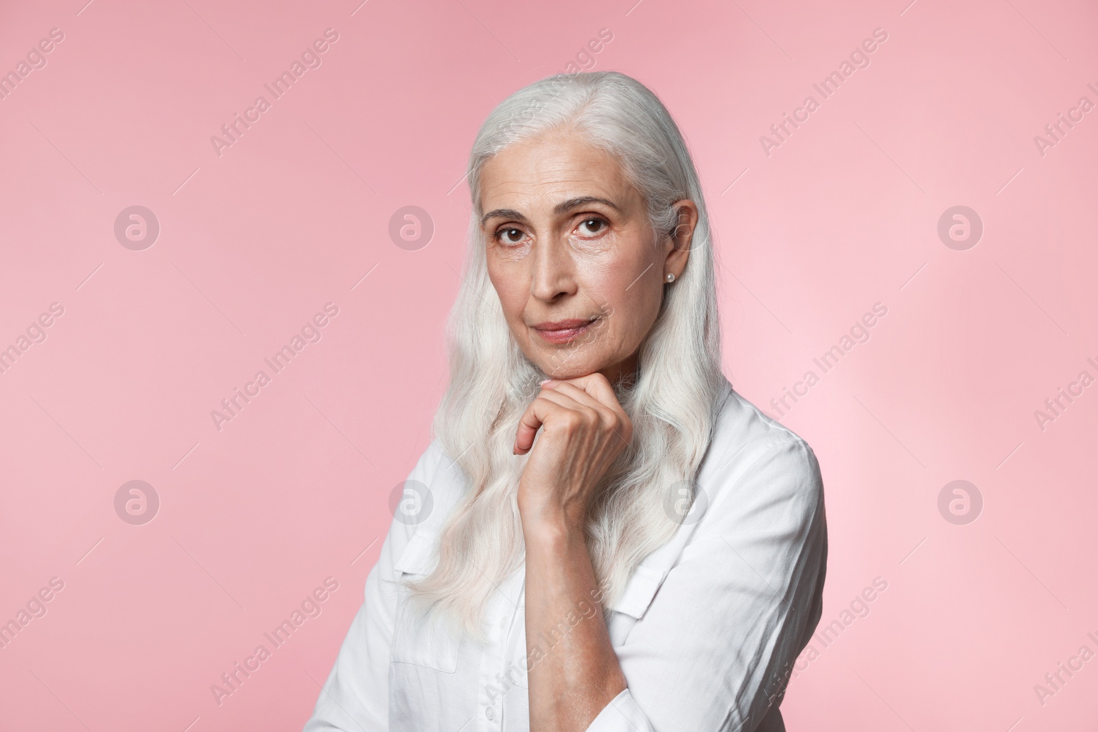 Photo of Portrait of beautiful mature woman on pink background