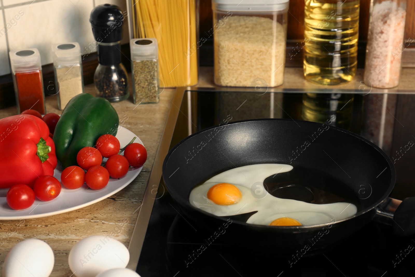 Photo of Cooking eggs for breakfast in frying pan on cooktop