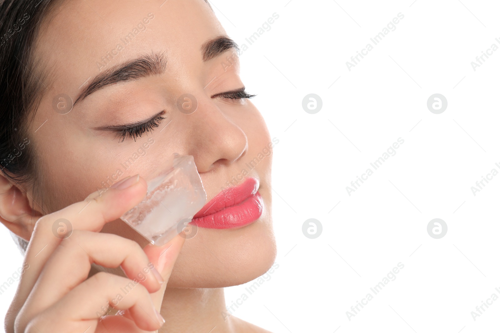 Photo of Young woman with ice cube on white background. Skin care