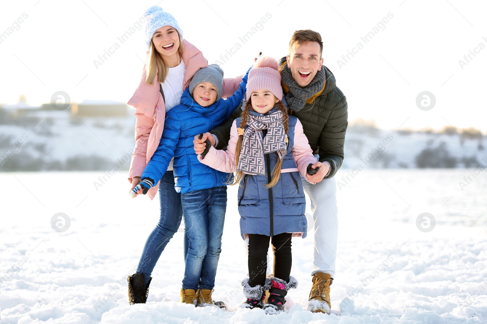 Photo of Portrait of happy family outdoors on winter day