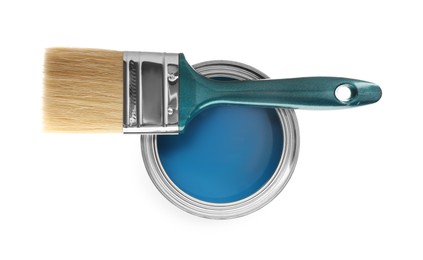 Photo of Can of blue paint and brush on white background, top view