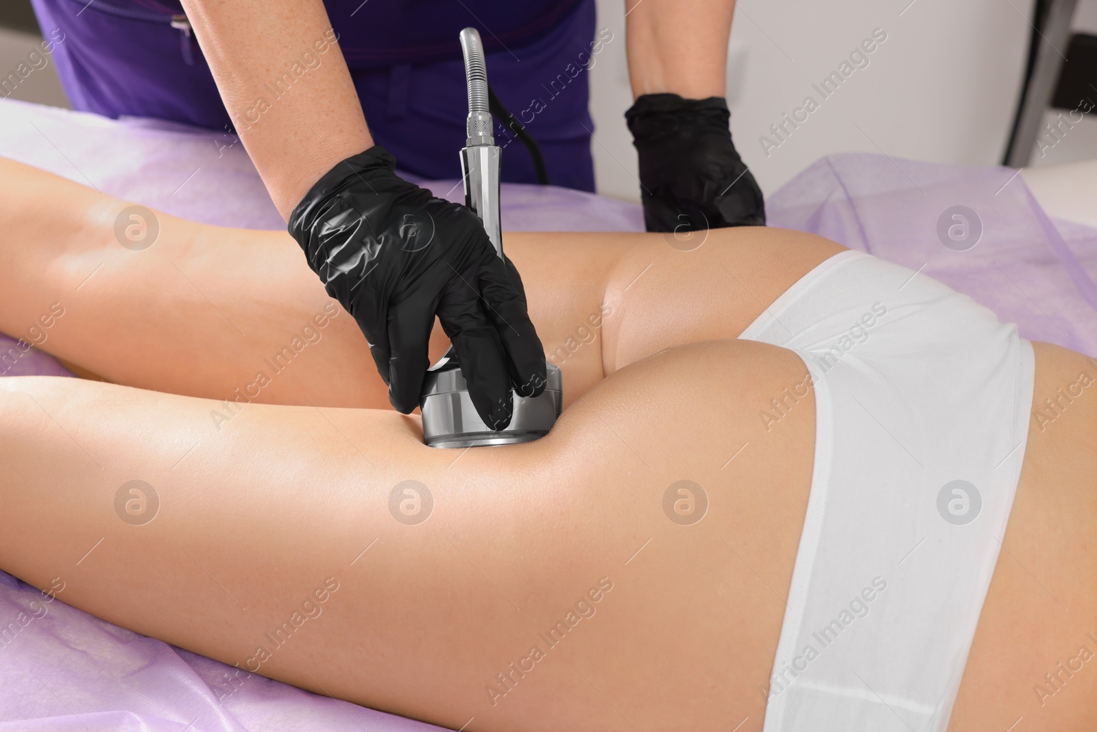 Photo of Woman undergoing radio frequency lifting procedure in beauty salon, closeup