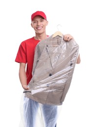 Photo of Dry-cleaning delivery. Happy courier holding jacket in plastic bag on white background