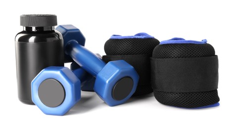 Photo of Dumbbells, plastic bottle and weights isolated on white