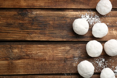 Snowballs on wooden background, flat lay. Space for text