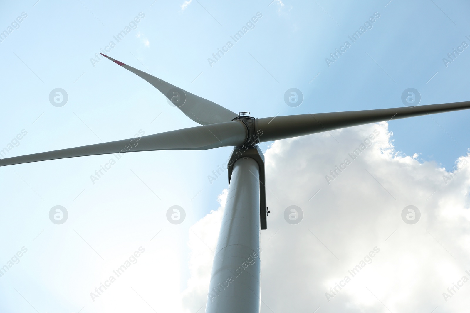 Photo of Modern wind turbine against blue sky, low angle view. Energy efficiency