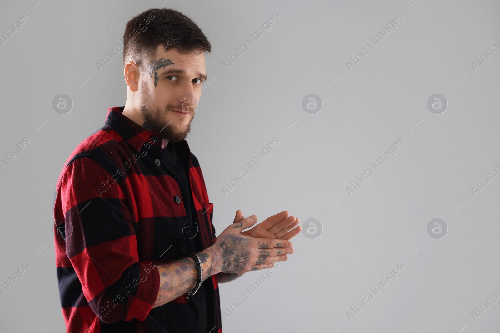 Photo of Portrait of handsome hipster man on light grey background. Space for text