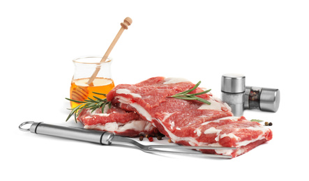 Photo of Raw ribs with herbs and pepper on white background