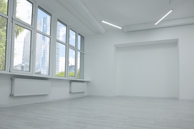 Photo of New empty room with clean windows and white walls