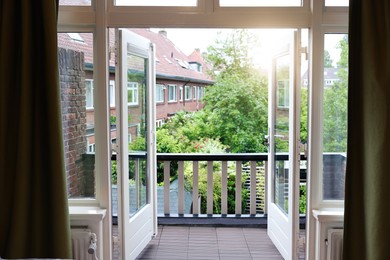 Beautiful view on balcony and inner yard with green trees from apartment