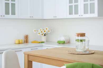 Photo of Stylish wooden table in beautiful kitchen interior