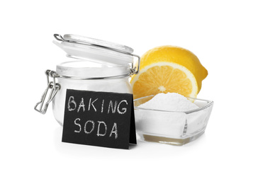 Photo of Baking soda and cut lemons on white background