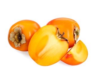 Photo of Whole and cut persimmon fruits isolated on white