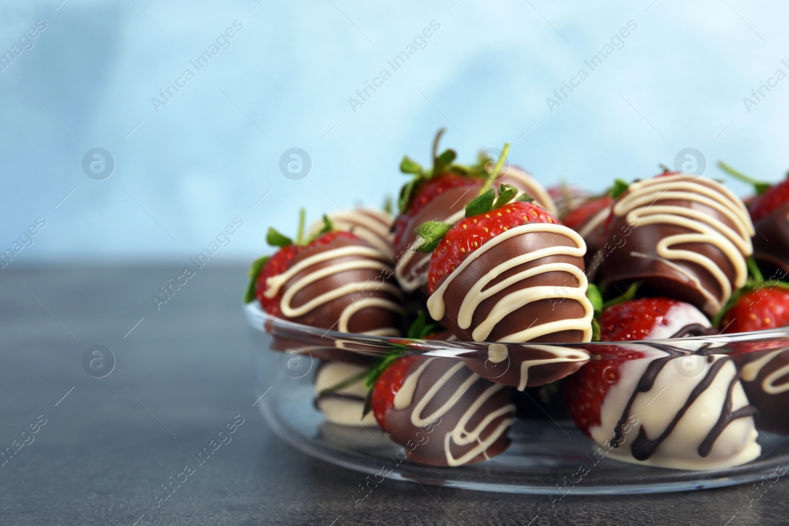 Photo of Plate with chocolate covered strawberries on table, closeup